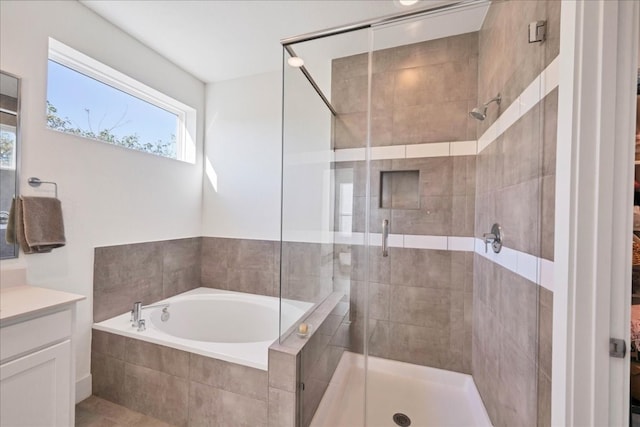 bathroom with vanity and independent shower and bath