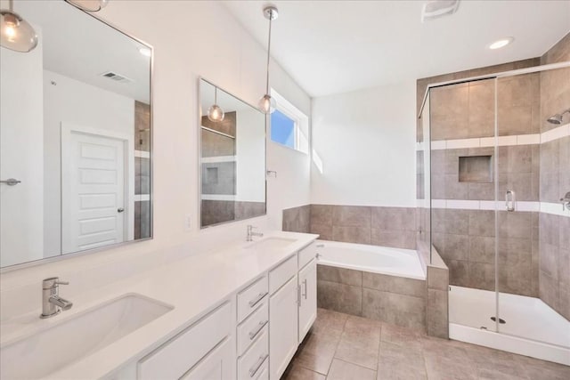 8922 Menchaca Rd Unit 906, Austin, TX 78748 - bathroom with a garden tub, a shower stall, double vanity, and tile patterned floors