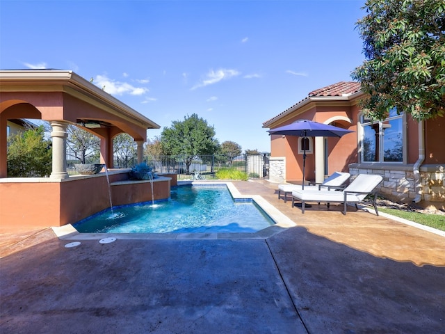 view of pool with pool water feature and a patio area