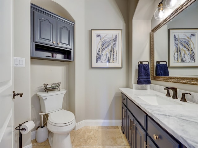 bathroom featuring tile patterned floors, vanity, and toilet