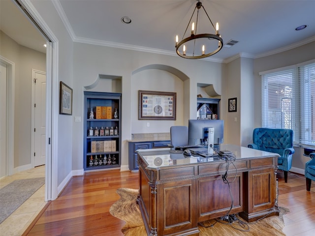 office space featuring crown molding, light hardwood / wood-style floors, and an inviting chandelier