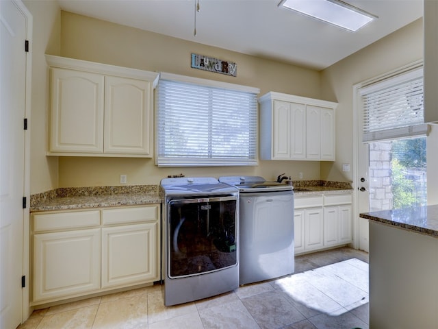 washroom featuring cabinets, separate washer and dryer, sink, and a wealth of natural light