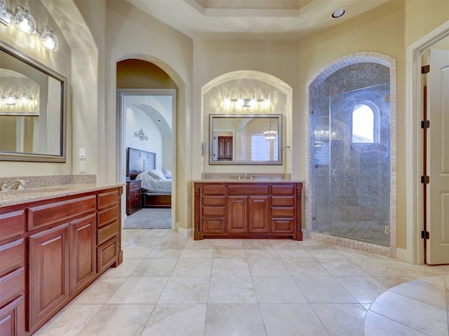 bathroom featuring tile patterned flooring, vanity, and walk in shower