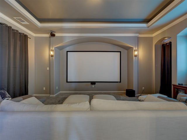 home theater with ornamental molding, carpet floors, and a tray ceiling