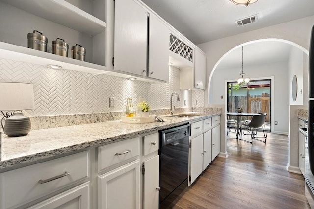 kitchen with dark wood-type flooring, sink, hanging light fixtures, black dishwasher, and white cabinetry