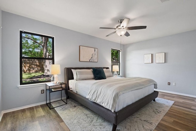 bedroom featuring dark hardwood / wood-style floors and ceiling fan