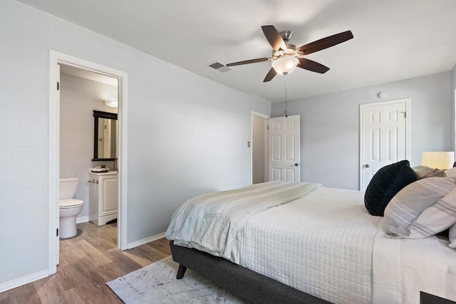 bedroom featuring ensuite bath, ceiling fan, a closet, and light hardwood / wood-style floors