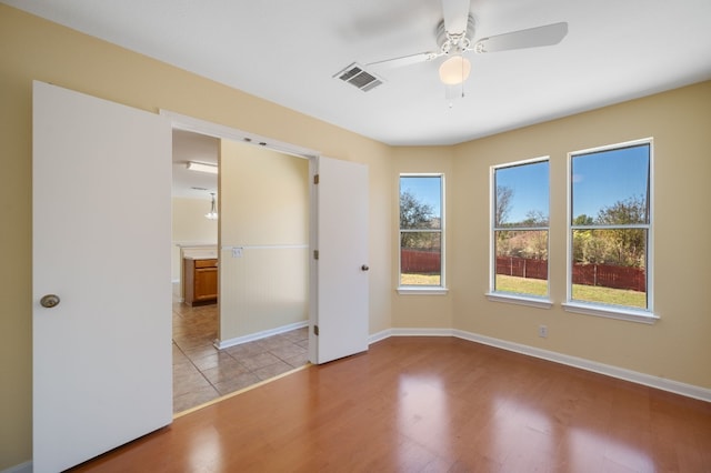 unfurnished bedroom with ceiling fan and light wood-type flooring