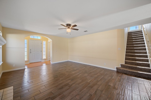 unfurnished living room with ceiling fan and dark hardwood / wood-style flooring