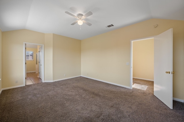 spare room with ceiling fan, light colored carpet, and lofted ceiling