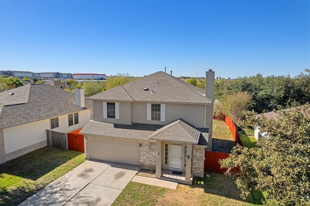 front facade with a garage and a front lawn