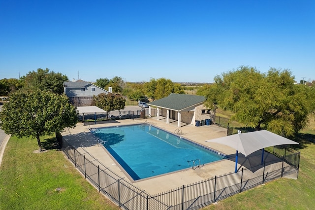 view of swimming pool with a lawn and a patio area