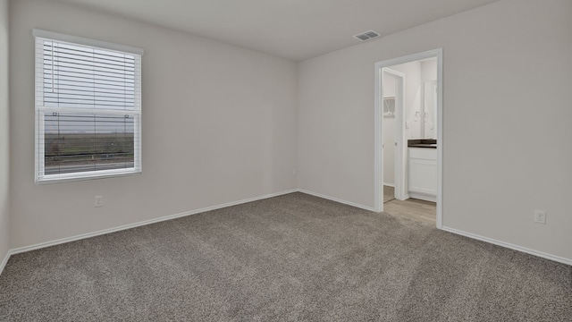 unfurnished room featuring light colored carpet