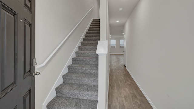 stairway with hardwood / wood-style flooring