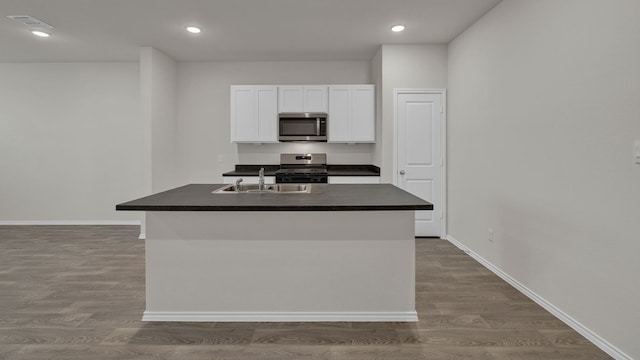 kitchen with sink, an island with sink, white cabinets, and appliances with stainless steel finishes