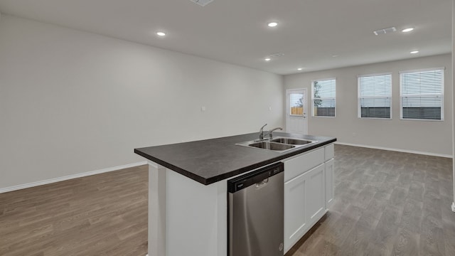 kitchen with sink, dishwasher, light hardwood / wood-style floors, an island with sink, and white cabinets