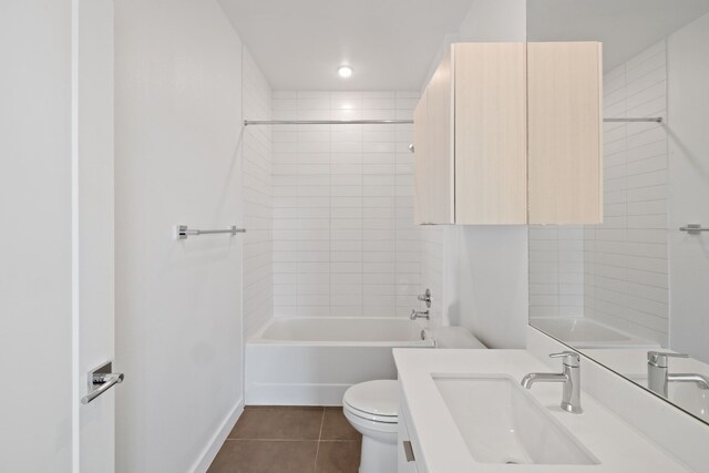 full bathroom featuring tile patterned flooring, vanity, toilet, and tiled shower / bath