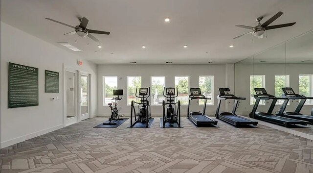 workout area with ceiling fan and light colored carpet