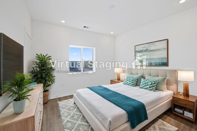 bedroom with dark hardwood / wood-style floors