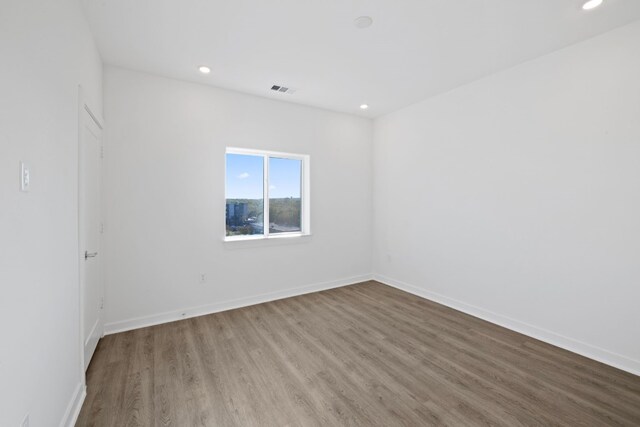 empty room with wood-type flooring