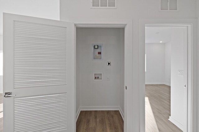 laundry room with electric dryer hookup, hookup for a washing machine, and light wood-type flooring