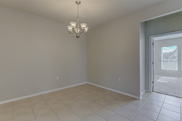 spare room with an inviting chandelier