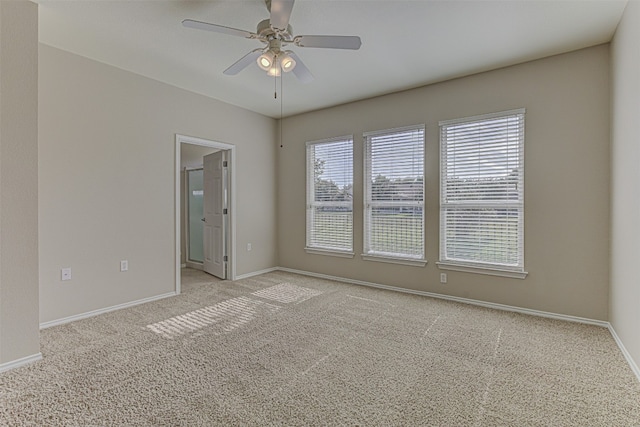 carpeted spare room with ceiling fan