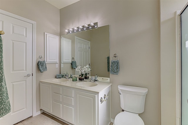 bathroom featuring tile patterned floors, vanity, and toilet