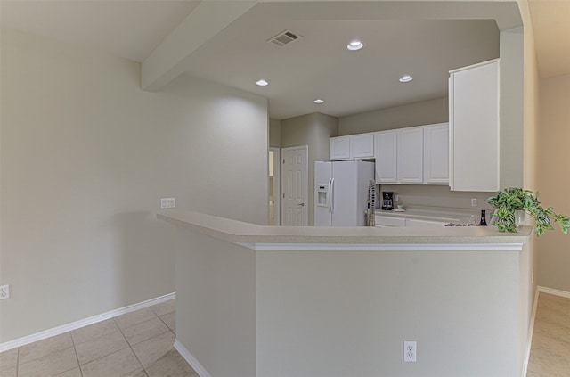 kitchen with white cabinetry, light tile patterned flooring, white refrigerator with ice dispenser, and kitchen peninsula