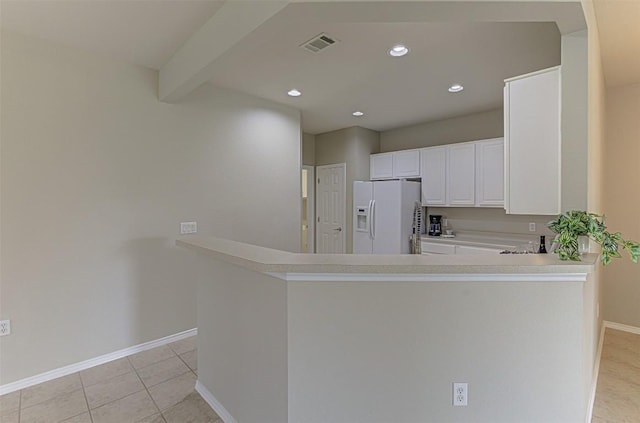 401 Bonham Loop, Georgetown, TX 78633 - kitchen featuring white cabinets, beam ceiling, light countertops, white fridge with ice dispenser, and baseboards