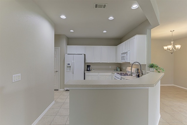 kitchen with white cabinetry, kitchen peninsula, pendant lighting, a chandelier, and white appliances