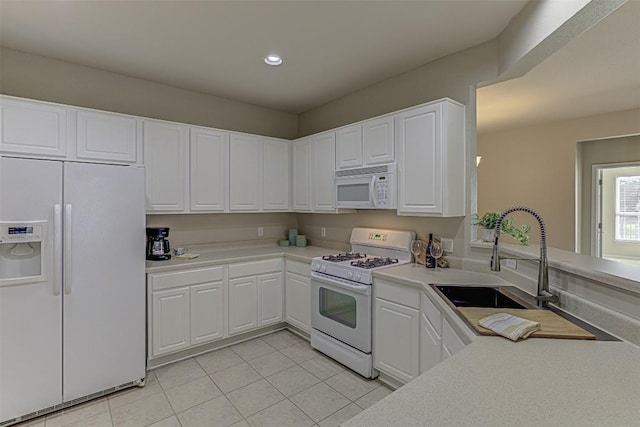401 Bonham Loop, Georgetown, TX 78633 - kitchen featuring light tile patterned flooring, a sink, white appliances, light countertops, and white cabinetry