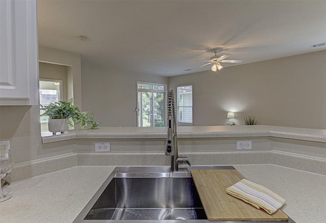 401 Bonham Loop, Georgetown, TX 78633 - kitchen with light countertops, ceiling fan, white cabinetry, and visible vents