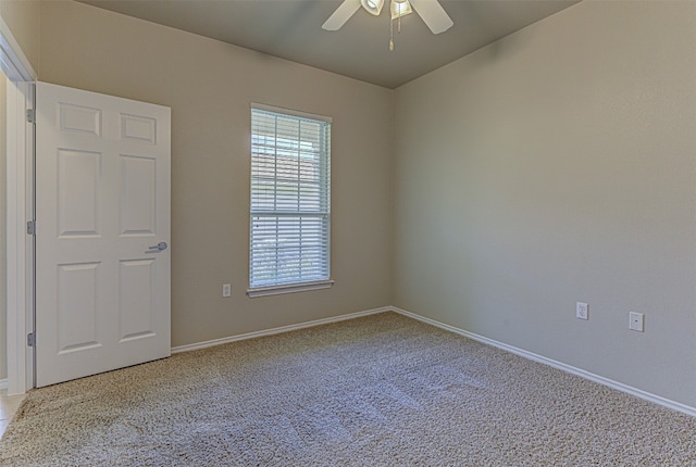 unfurnished room featuring ceiling fan and light colored carpet