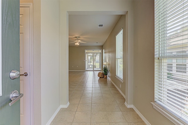 hall featuring light tile patterned floors