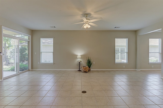 tiled empty room with ceiling fan