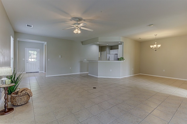 unfurnished living room featuring ceiling fan with notable chandelier and light tile patterned floors