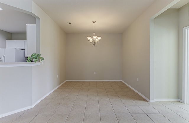 unfurnished room with light tile patterned floors and an inviting chandelier