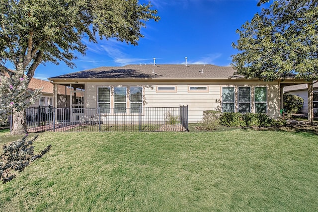 back of property with a lawn and a sunroom