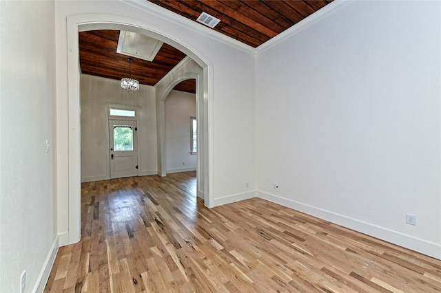 entrance foyer featuring light hardwood / wood-style flooring, wood ceiling, a notable chandelier, and ornamental molding