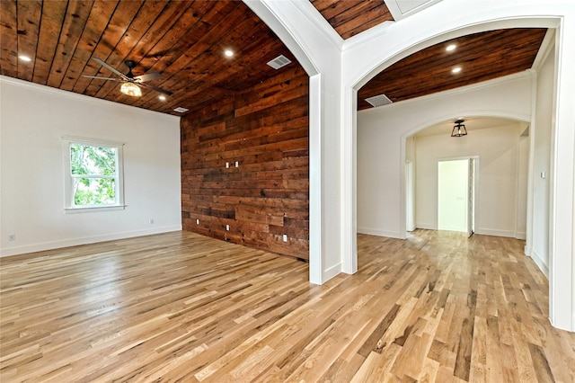 unfurnished room with ceiling fan, crown molding, light hardwood / wood-style flooring, wooden ceiling, and wood walls