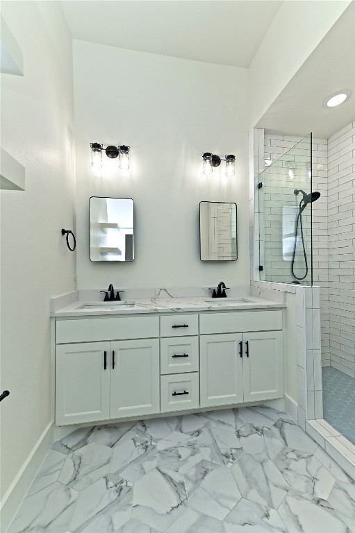 bathroom featuring vanity and tiled shower