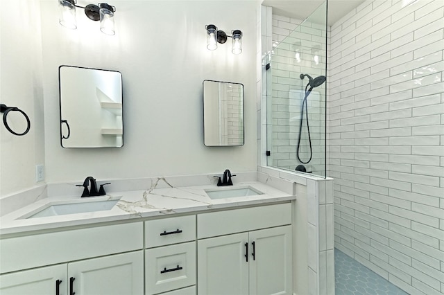 bathroom with tiled shower and vanity