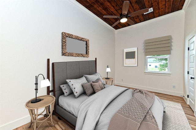 bedroom featuring ceiling fan, light hardwood / wood-style floors, wood ceiling, and crown molding