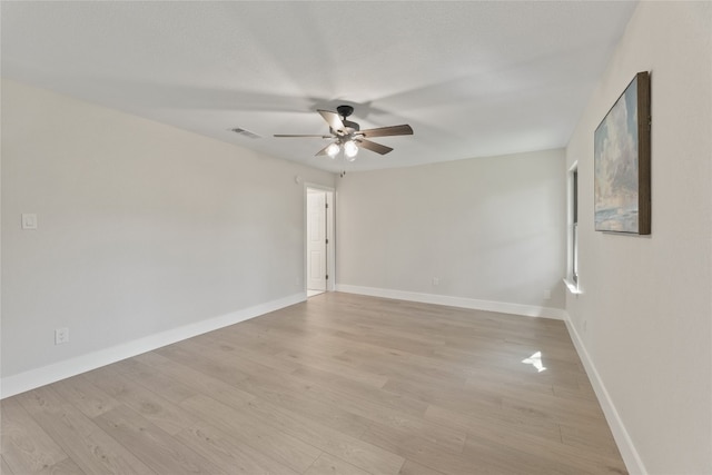 unfurnished room with ceiling fan, light wood-type flooring, and a textured ceiling