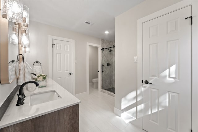 bathroom featuring vanity, an enclosed shower, and toilet