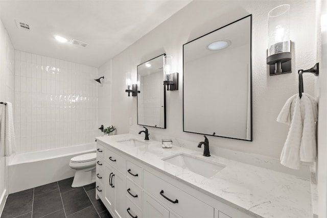 full bathroom featuring tile patterned flooring, vanity, tiled shower / bath combo, and toilet