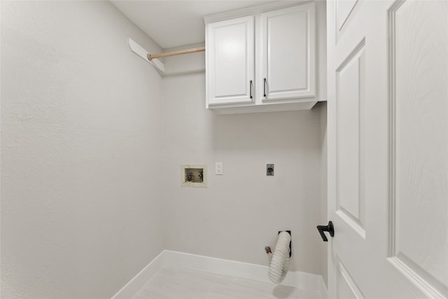 laundry area featuring hookup for an electric dryer, cabinets, light tile patterned floors, and washer hookup