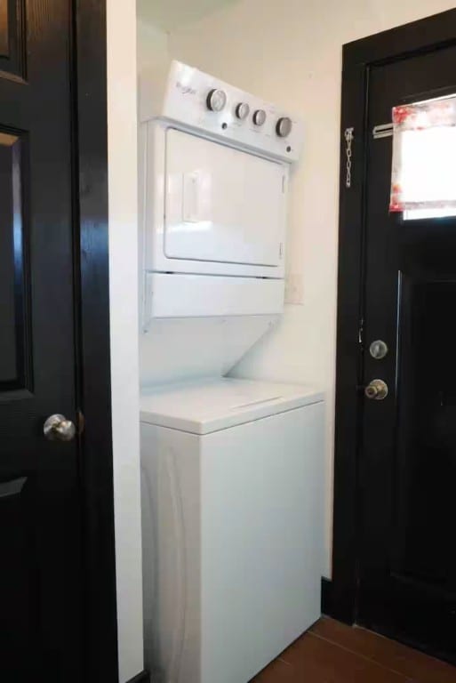 laundry room featuring stacked washer / drying machine