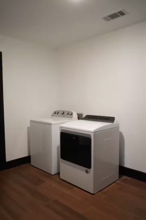 washroom featuring dark hardwood / wood-style flooring and independent washer and dryer